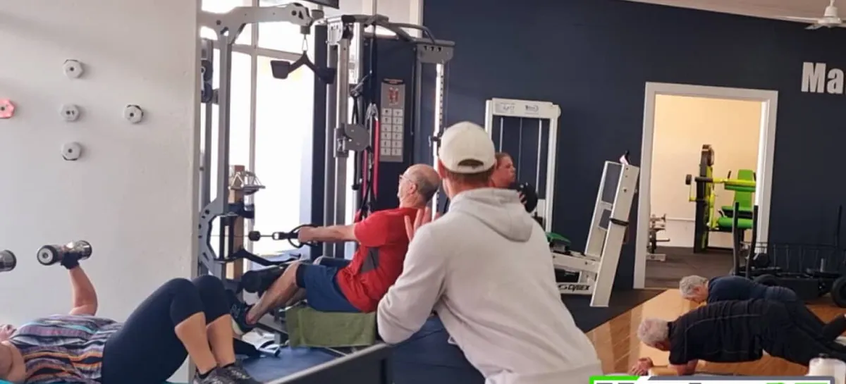 A group session at the MarionPT studio, with clients working on the cable machine, free weights and floor exercises while a trainer coaches