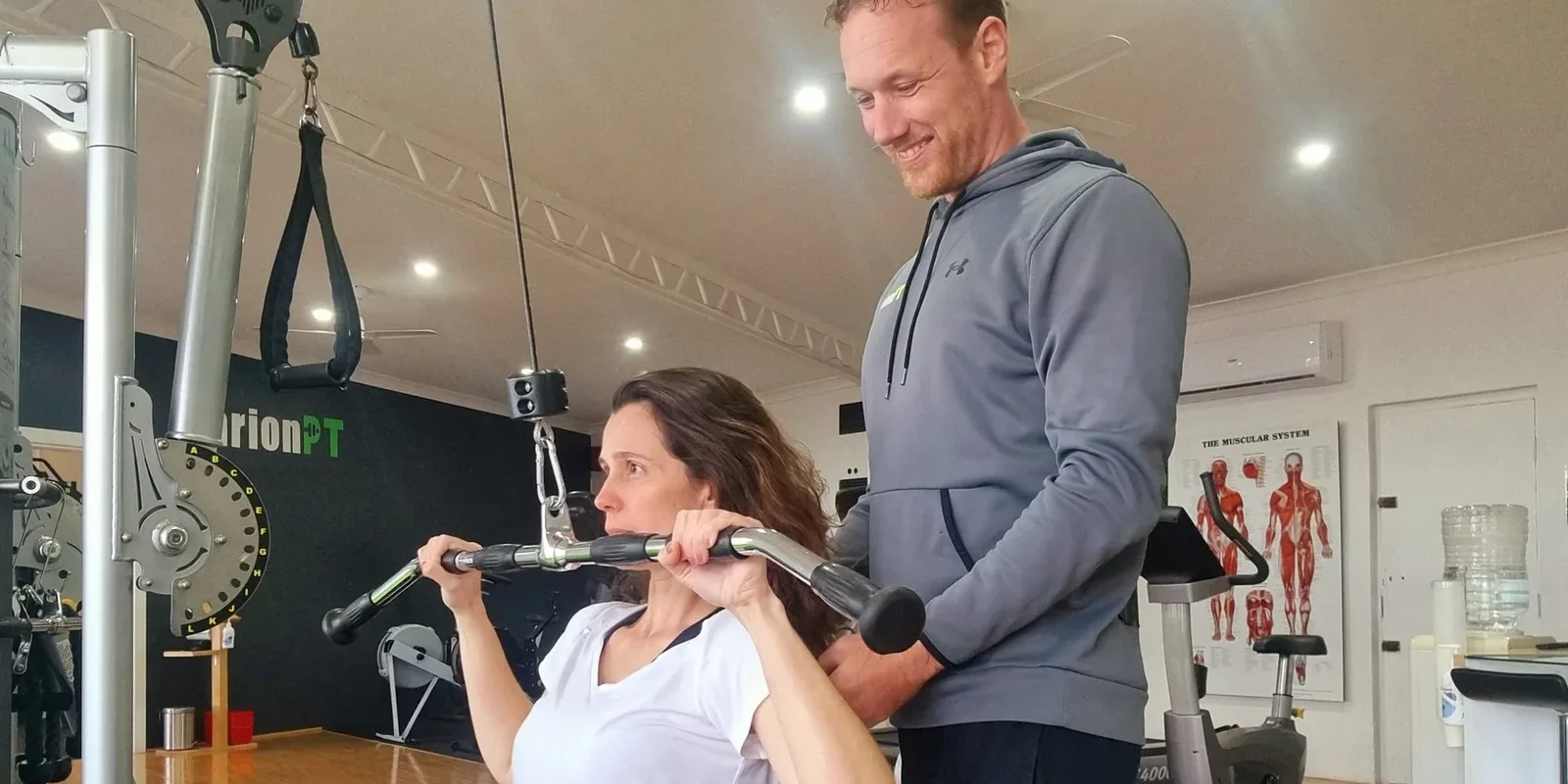 Henk coaching a client through a lat pulldown in the MarionPT studio in Warradale
