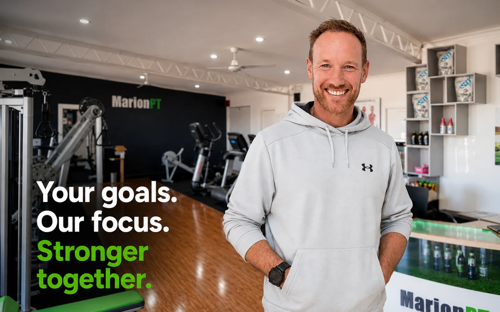 Henk in the MarionPT studio in Warradale, beside the words: Your goals. Our focus. Stronger together.