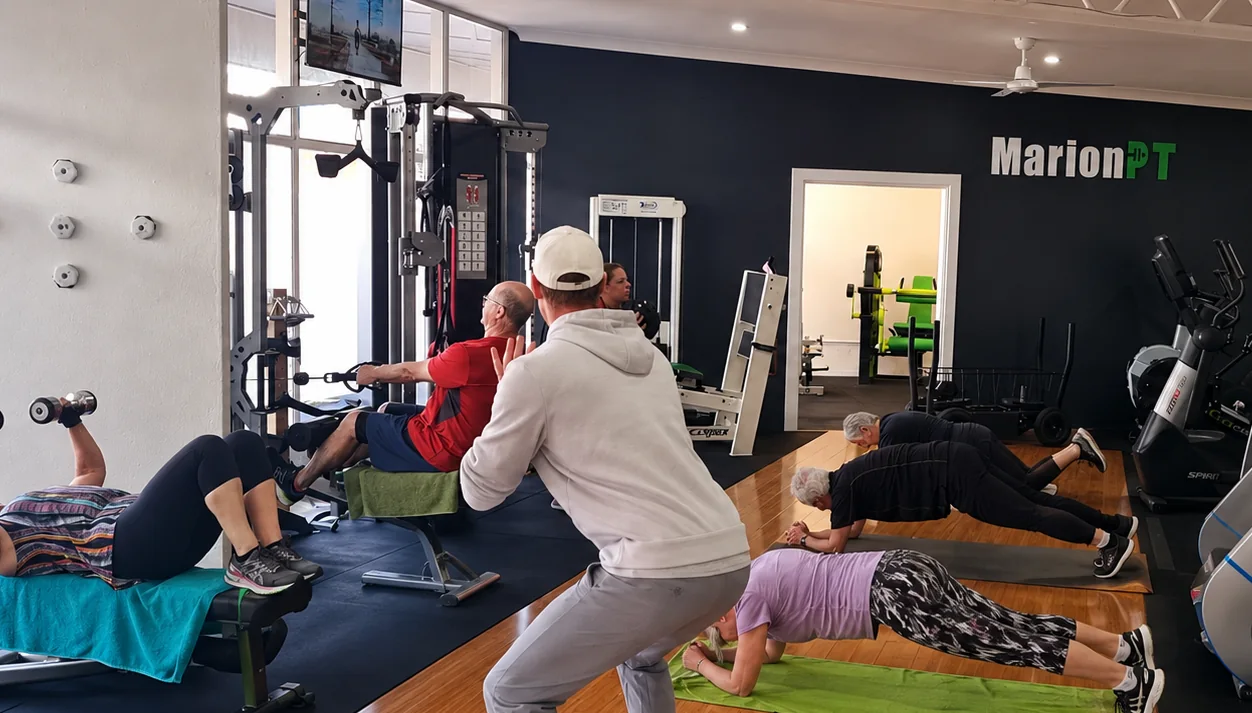 A Fit Vibes small-group session in progress at the MarionPT studio, members working through mat exercises with their coach