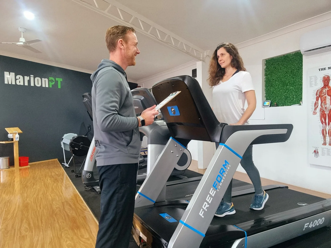 A MarionPT coach setting up a member on the treadmill in the Warradale studio